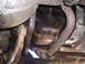 1985 Ford Bronco - Underside view of a vehicle's engine pan and exhaust pipe, showing oil accumulation.