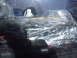 1985 Ford Bronco - Parts are wrapped in plastic and stored on the back seat of a vehicle.