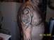 1989 Ford Bronco - A man displays a tattoo on his arm tribal art and a whimsical cartoon figure.