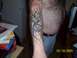 1989 Ford Bronco - Tattoo on arm with tribal design and a cross symbol.