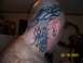 1989 Ford Bronco - A man displays extensive tribal tattoos covering his head and neck, including flame designs.
