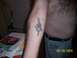 1989 Ford Bronco - A tattoo is visible on a person's arm, alongside books and a fan, with a date stamp of 02/18/2005.