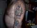 1989 Ford Bronco - A tattoo on an arm features a figure surrounded by flames and the word 'RUMBA'.