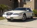 1997 Lincoln Mark VIII - A white 1997 Lincoln Mark VIII is parked in a driveway with a house in the background.