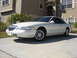 1997 Lincoln Mark VIII - A white 1997 Lincoln Mark VIII is parked on a concrete driveway in front of a beige house.