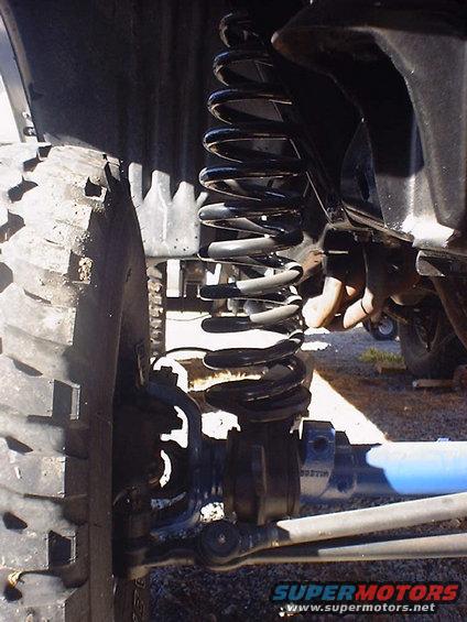 Close-up of suspension and tire with Supermotors logo