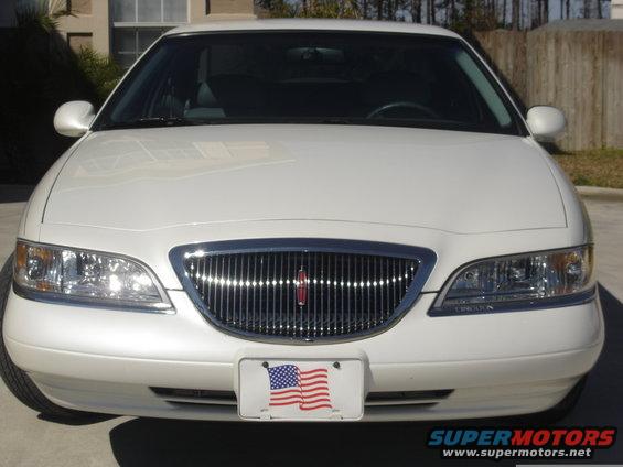 White 1997 Lincoln Mark VIII front view with chrome grille and American flag license plate frame