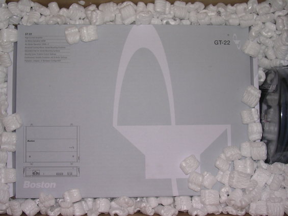 Cardboard box with packing peanuts, showing a Boston GT-22 amplifier with diagrams and text