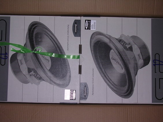 Two boxes with images of Boston Performance 12-inch subwoofers, one tied with green tape