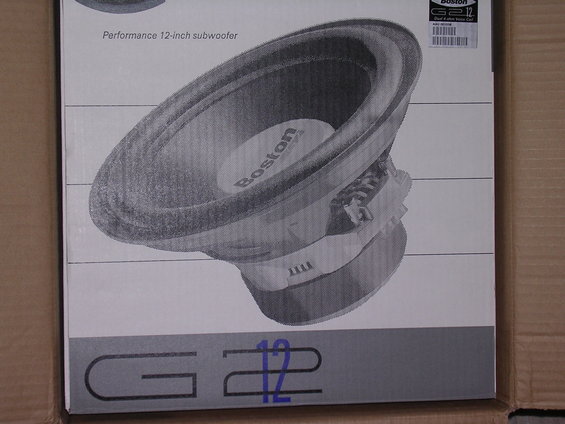 Boston G2 12-inch subwoofer shown on its box, which also has text and a barcode