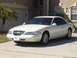 1997 Lincoln Mark VIII - This 1997 Lincoln Mark VIII coupe is shown in a three-quarter front view, parked in front of a residential garage.