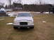 1992 Lincoln Mark VII - A silver sedan is parked in a grassy area with a few patches of snow visible.