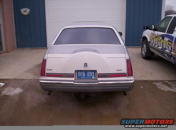 Rear view of a 1992 Lincoln Mark VII with a spare tire cover and a blue license plate