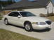 1997 Lincoln Mark VIII - A white 1997 Lincoln Mark VIII coupe is parked in front of a house.