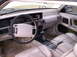 1992 Lincoln Mark VII - The interior of a 1992 Lincoln Mark VII features a beige dashboard, steering wheel, and leather seats.