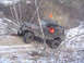 1979 Ford Bronco - Off-road vehicle navigating a difficult trail and getting stuck amongst trees.