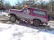 1979 Ford Bronco - This two-tone SUV navigates a challenging off-road course with icy patches and rocks.