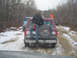 1979 Ford Bronco - Red Ford Bronco with spare tire on back, license plate CRT-1991, on a snowy dirt road with other vehicles.