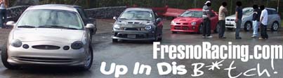 Several cars and people standing around on a wet surface. Text overlay reads 'FresnoRacing.com Up In Dis B*tch!'