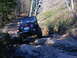 1990 Ford Bronco - This off-road vehicle tackles a challenging rocky path with a steep incline.