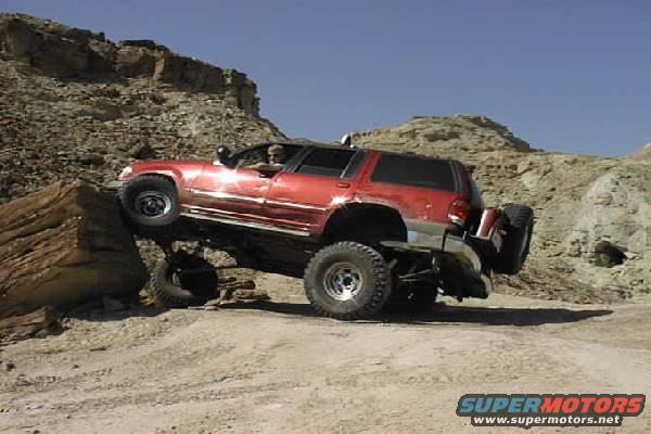 Jeff, in our group, gets a wheel up on top of a 5 ft high rock