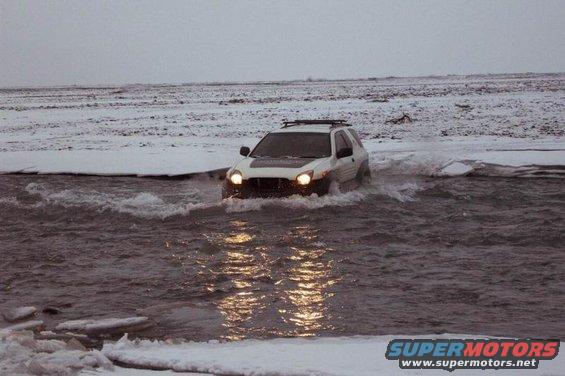 White 2001 Isuzu Vehicross driving through water, front view