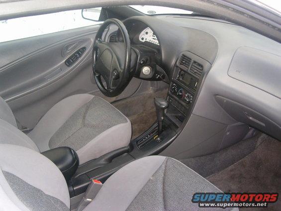 Interior view of a 1994 Ford Probe, showing the dashboard, steering wheel, seats, and center console