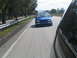 1998 Volkswagen Jetta - A blue 1998 Volkswagen Jetta is seen driving on a road, captured from another vehicle.
