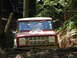 1975 Ford Bronco - This 1975 Ford Bronco is tackling a challenging off-road course with another vehicle in the background.
