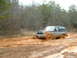 1991 Ford Bronco - This 1991 Ford Bronco is deep in the mud, struggling to move forward on a wet, wooded trail.