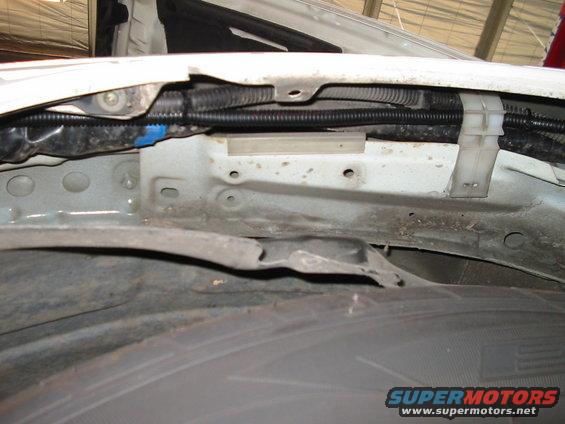 Close-up of wheel well and fender liner with wiring harness