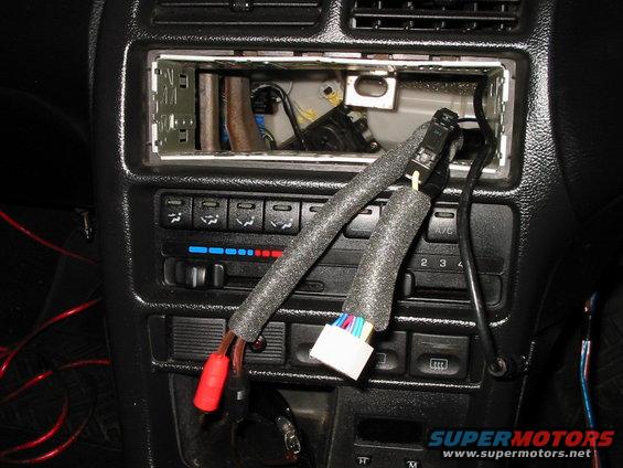 Car stereo wiring with red connectors and a white plug