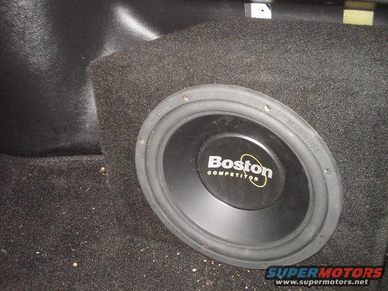 Subwoofer in carpeted enclosure, visible Boston Competitor logo, "Made in USA" text