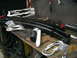 1981 Chevrolet C/K Pickup - Parts laid out on a workbench, including leaf springs, U-bolts, and shock absorbers, with boxes of 'PRO' parts visible.