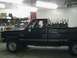 1981 Chevrolet C/K Pickup - A black 1981 Chevrolet C/K Pickup truck is parked inside a garage.