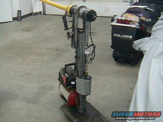 Custom apparatus with yellow arm and air compressor