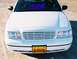 2000 Ford Crown Victoria - Front view of a white 2000 Ford Crown Victoria, showing the grille and headlights.