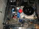1968 Ford Mustang - The engine bay of a 1968 Ford Mustang features a V8 engine with chrome valve covers and a prominent air cleaner assembly.