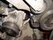 1992 Ford Crown Victoria - Engine component detail, likely a pulley system part, with visible wear and fluid stains.