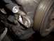 1992 Ford Crown Victoria - Close-up view of an engine component with a ribbed pulley and visible bolts.