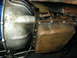 1968 Ford Mustang - Underside view of a transmission oil pan and bell housing, with visible bolts and signs of wear.