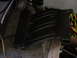 1998 Volkswagen Jetta - A black plastic intake manifold is shown resting on a surface, with various tools and parts in the background.