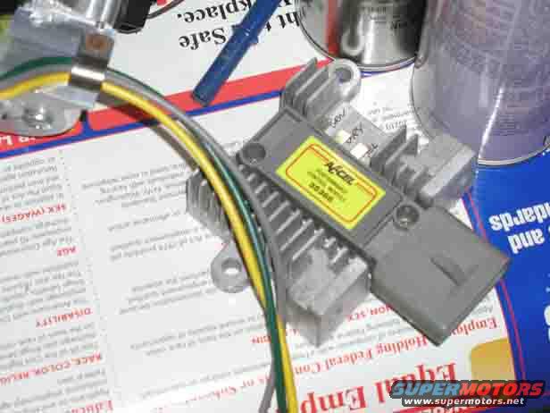 Accel ignition module with yellow label and wires, on top of documents