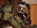 1988 Ford Bronco - A gas mask, filter, canteen, and medical pouch are laid out on the floor, suggesting military deployment gear.