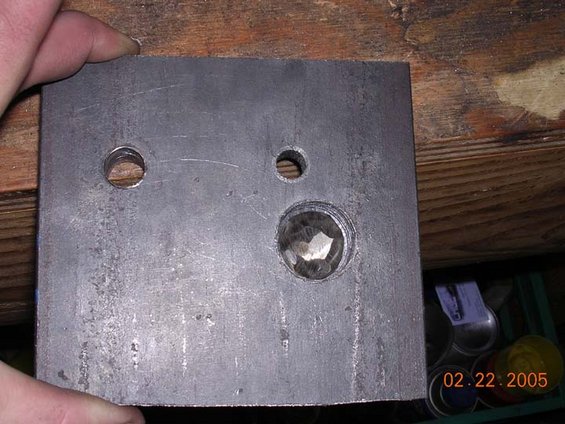 bottomcoilbracket.jpg wholes drilled.  the bottom is drilled large to allow the head of a 5/8 bolt to fit.  You do grind down the head of the bolt, and then weld it in place.