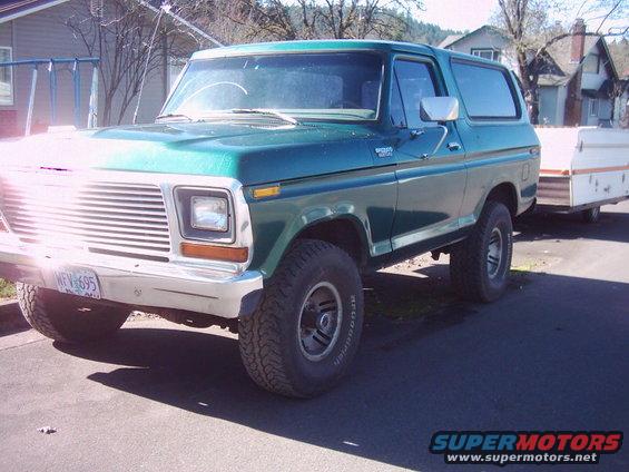 Green 1978 Ford Bronco with a white trailer