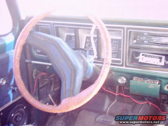 1978 Ford Bronco interior showing steering wheel, dashboard gauges, and radio