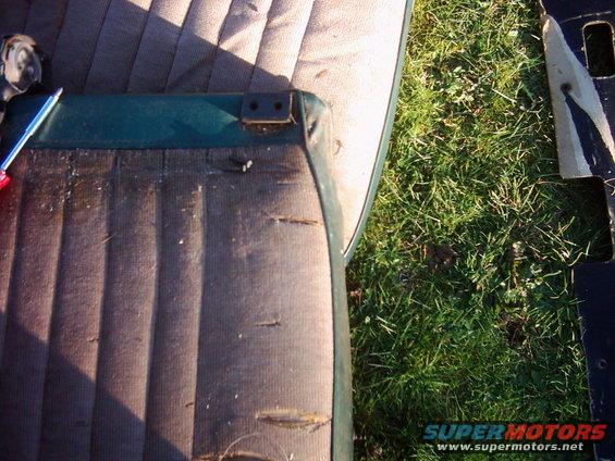 1978 Ford Bronco interior seat with torn upholstery and visible mounting hardware