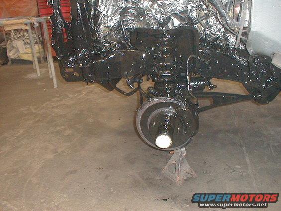 Black painted truck frame and suspension on jack stands