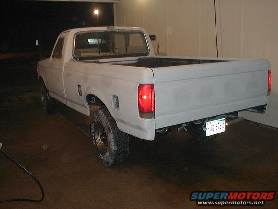 1991 Ford F-150 pickup truck, primer gray, parked indoors
